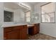 Bathroom with double sinks and vanity area, complemented by a large mirror at 7205 W Ellis St, Laveen, AZ 85339