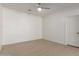 Bright, minimal bedroom with wood-look floors and a ceiling fan at 7205 W Ellis St, Laveen, AZ 85339