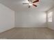 Spacious bedroom with wood-look floors and ceiling fan offers a relaxing retreat at 7205 W Ellis St, Laveen, AZ 85339