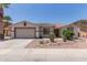 Charming single-story home featuring desert landscaping, a neutral color palette, and a two-car garage at 7205 W Ellis St, Laveen, AZ 85339