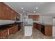 Open kitchen with ample counter space, island, and modern appliances is spacious at 7205 W Ellis St, Laveen, AZ 85339