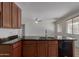Kitchen features granite countertops, wood cabinetry, and sleek, modern appliances at 7205 W Ellis St, Laveen, AZ 85339