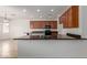 Well-lit kitchen with dark countertops and wood cabinets is spacious and functional at 7205 W Ellis St, Laveen, AZ 85339