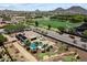 Lovely backyard with an outdoor kitchen, a pool, spa, putting green, and gas fire pit at 7205 W Fallen Leaf Ln, Peoria, AZ 85383