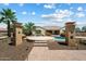 Spacious backyard with a pool, patio, and lush landscaping, ideal for outdoor gatherings and enjoyment at 7205 W Fallen Leaf Ln, Peoria, AZ 85383