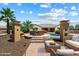 Expansive backyard with a pool, outdoor dining area, and lush landscaping for luxurious outdoor living at 7205 W Fallen Leaf Ln, Peoria, AZ 85383