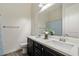 Bathroom with double sinks, white marble countertops and dark wood cabinets at 7205 W Fallen Leaf Ln, Peoria, AZ 85383