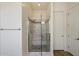 A bright bathroom with a stand-up shower featuring glass doors and bright white walls at 7205 W Fallen Leaf Ln, Peoria, AZ 85383