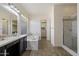 A well-lit bathroom featuring a double vanity, soaking tub and a tiled shower at 7205 W Fallen Leaf Ln, Peoria, AZ 85383