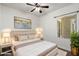 Inviting bedroom with a cozy bed, stylish lamps, and a soothing color scheme at 7205 W Fallen Leaf Ln, Peoria, AZ 85383