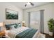 Bedroom with a large mirror, queen bed, and a window with natural light at 7205 W Fallen Leaf Ln, Peoria, AZ 85383