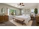 Bright bedroom with a large window, ceiling fan, and elegant decor for a relaxing space at 7205 W Fallen Leaf Ln, Peoria, AZ 85383