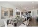 Charming dining area with a glass-top table, upholstered chairs, and a view of the modern kitchen at 7205 W Fallen Leaf Ln, Peoria, AZ 85383