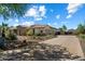 Well maintained single-Gathering house with stone accents, desert landscaping, and paver driveway at 7205 W Fallen Leaf Ln, Peoria, AZ 85383