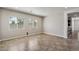 Large open living space with tile flooring and a view of the adjacent kitchen at 7205 W Fallen Leaf Ln, Peoria, AZ 85383