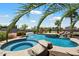 Luxury pool and spa with tropical landscaping for serene relaxation and outdoor entertainment at 7205 W Fallen Leaf Ln, Peoria, AZ 85383