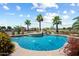 Inviting pool with rock features, fountains, and lush landscaping, creating a tropical oasis at 7205 W Fallen Leaf Ln, Peoria, AZ 85383