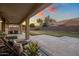 View of the covered back patio with a large yard that is great for entertaining friends and Gathering at 7616 S Sorrell Ln, Gilbert, AZ 85298