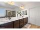 Bright bathroom featuring double sinks, modern fixtures, white countertops and decorative accents at 7616 S Sorrell Ln, Gilbert, AZ 85298