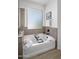 Serene bathroom featuring a soaking tub with stylish fixtures, and tile accents for a luxurious feel at 7616 S Sorrell Ln, Gilbert, AZ 85298
