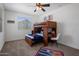 Fun bedroom featuring a bunk bed with a desk, playful decor, and bright natural light at 7616 S Sorrell Ln, Gilbert, AZ 85298
