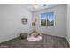Bright bedroom featuring natural light, playful decor, and a cozy rug creating an inviting space at 7616 S Sorrell Ln, Gilbert, AZ 85298