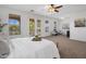 Bright bedroom showcasing a ceiling fan and balcony access with comfortable seating at 7616 S Sorrell Ln, Gilbert, AZ 85298