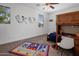 Fun bedroom featuring a bunk bed with a desk, playful decor, and bright natural light at 7616 S Sorrell Ln, Gilbert, AZ 85298