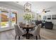 Open dining area features a round table, seating for four, and natural light from the sliding glass doors to the backyard at 7616 S Sorrell Ln, Gilbert, AZ 85298