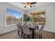 Cozy dining room with a wood table and multiple windows at 7616 S Sorrell Ln, Gilbert, AZ 85298