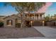 Two-story home featuring a two-car garage, low-maintenance landscaping, and a second-story balcony at 7616 S Sorrell Ln, Gilbert, AZ 85298