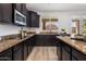 Modern kitchen features granite counters, stainless appliances, and ample cabinet space at 7616 S Sorrell Ln, Gilbert, AZ 85298