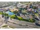 Aerial view of lush landscaping, water feature, and clubhouse with ample parking at 906 Leisure World --, Mesa, AZ 85206
