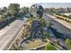 Aerial view of the community featuring palm trees, landscaping, and main road with globe monument at 906 Leisure World --, Mesa, AZ 85206