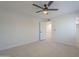 Bedroom featuring ceiling fan, carpet floors, closet and door to other rooms at 906 Leisure World --, Mesa, AZ 85206