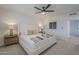 Bright bedroom featuring a ceiling fan, carpet floors, and decor on the nightstands at 906 Leisure World --, Mesa, AZ 85206