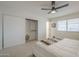 Well-lit bedroom with neutral carpet, a ceiling fan, and a closet at 906 Leisure World --, Mesa, AZ 85206