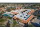 Aerial view of a clubhouse featuring a pool, ample parking, and well-maintained landscaping at 906 Leisure World --, Mesa, AZ 85206