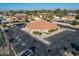 Aerial view of a RE/MAX building with ample parking, surrounded by well-kept landscaping and mature trees at 906 Leisure World --, Mesa, AZ 85206