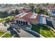 Aerial view showcases a community building nestled near a tranquil pond and mature trees at 906 Leisure World --, Mesa, AZ 85206