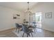 Dining area featuring a modern glass table and stylish pendant lighting at 906 Leisure World --, Mesa, AZ 85206