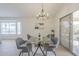 Bright dining space with a glass table and an open view to a desert backyard at 906 Leisure World --, Mesa, AZ 85206