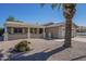 Tan home with a desert rock yard and front patio cover at 906 Leisure World --, Mesa, AZ 85206