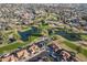 Wide shot of a golf course with strategically placed water hazards, trees, and surrounding homes at 906 Leisure World --, Mesa, AZ 85206