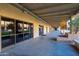 Covered hallway with decorative plants, window views, and community billiard room at 906 Leisure World --, Mesa, AZ 85206