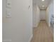 Well-lit hallway with wood-look floors, leading to other areas of the home at 906 Leisure World --, Mesa, AZ 85206