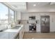 Modern kitchen with white quartz counters, stainless steel appliances, and a large window offering natural light at 906 Leisure World --, Mesa, AZ 85206