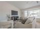 The living room features a comfortable sofa and chair set with neutral decor and a large window at 906 Leisure World --, Mesa, AZ 85206