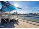 Shaded tennis court with net and covered bleachers offers a great space for community sporting activities at 906 Leisure World --, Mesa, AZ 85206
