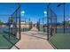 View through the gate of multiple well-maintained tennis courts and shaded walkways at 906 Leisure World --, Mesa, AZ 85206